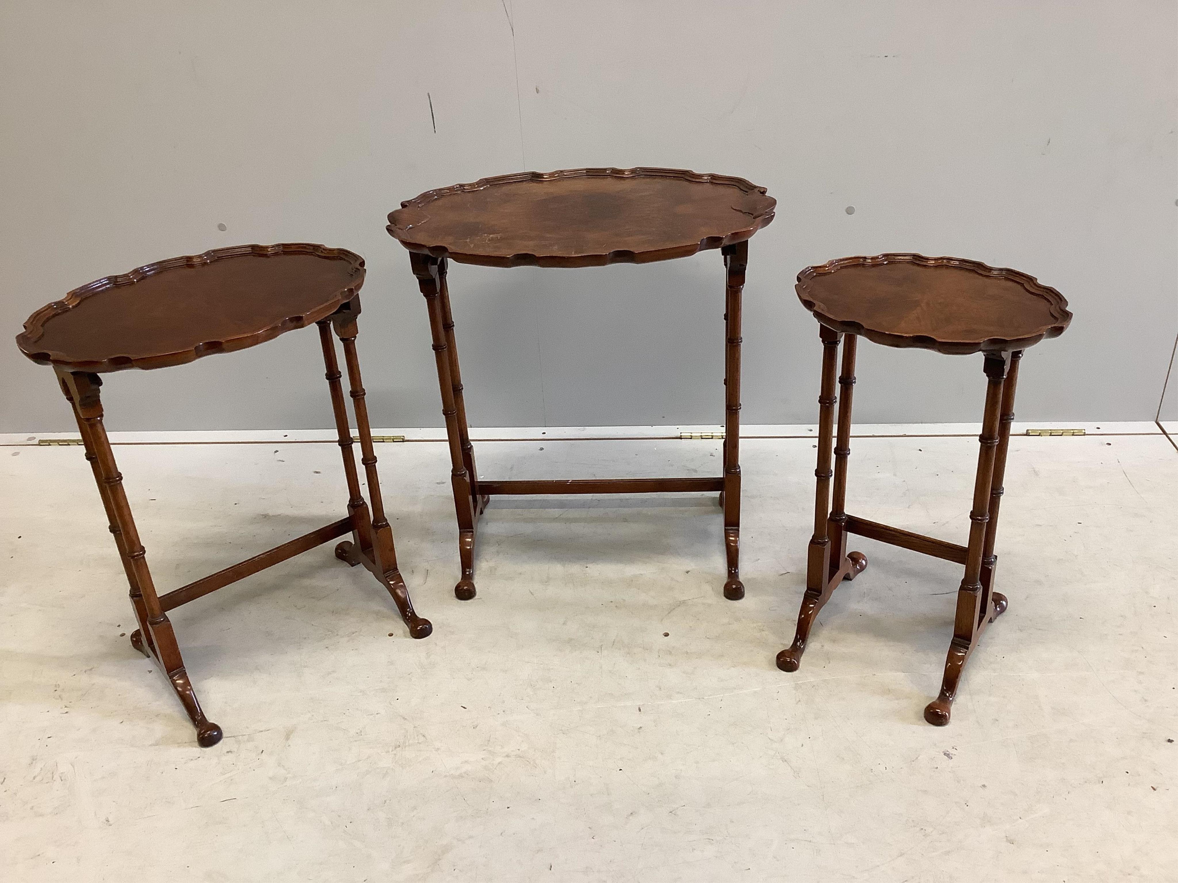 A nest of three burr walnut oval tea tables, width 56cm, depth 38cm, height 62cm. Condition - fair